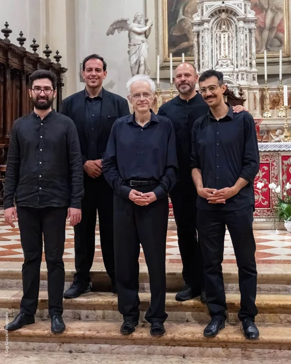 Cinque musicisti posano davanti a un altare dopo il concerto